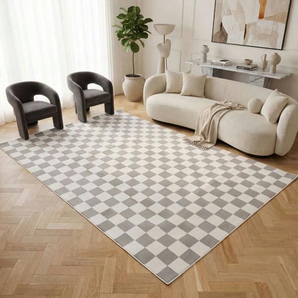 Living room with a checkered rug, beige sofa, and modern decor.