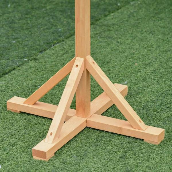 Wooden bird feeder base with cross-shaped legs and grounded support feet on grass