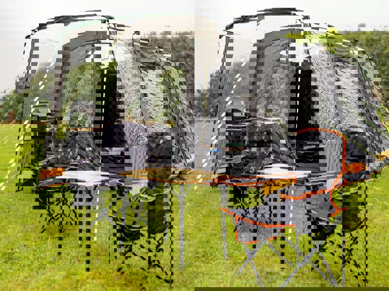 Image of Henwick Padded Folding Camp Chair Orange & Black by OLPRO lifestyle with bamboo compact table.