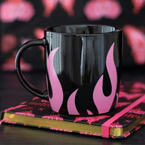 Black ceramic mug with glossy finish and pink flame graphics, wide handle and rim
