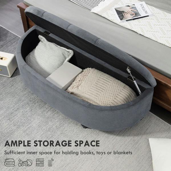 Dark grey half-circle storage ottoman with lid open, showing padded interior bin