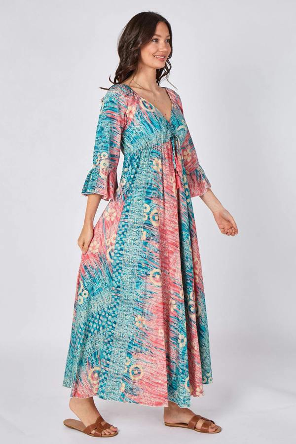 Woman wearing a colorful patterned dress on a white background