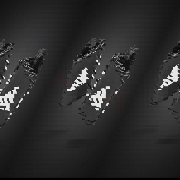 Black wrist wraps with white Adidas logo on a dark background