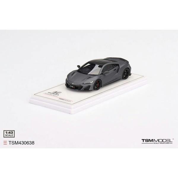 a grey toy car on a white surface