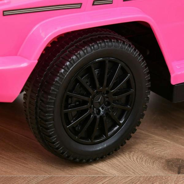 Pink ride-on push car front wheel with textured tire and black alloy rim