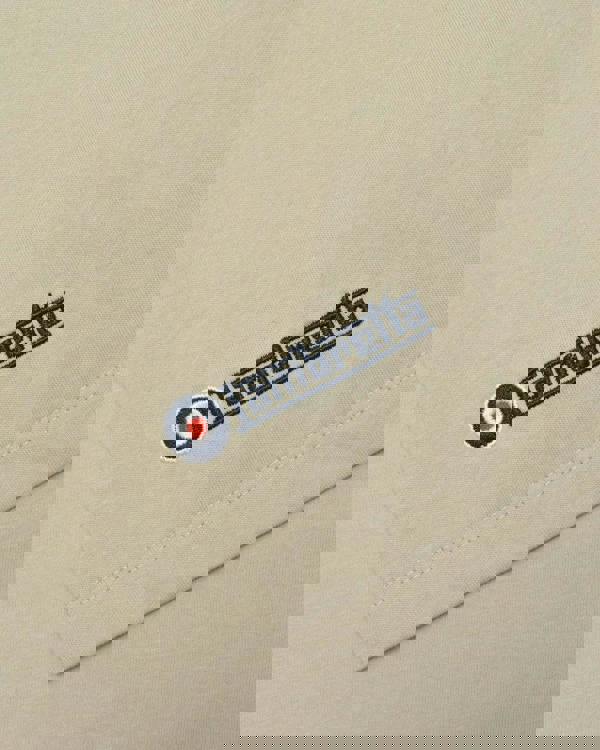 Lambretta Mens Scooter Logo Graphic Mod Ska Casual T-Shirts, close-up of beige fabric with embroidered Lambretta logo and Mona Lisa target symbol.