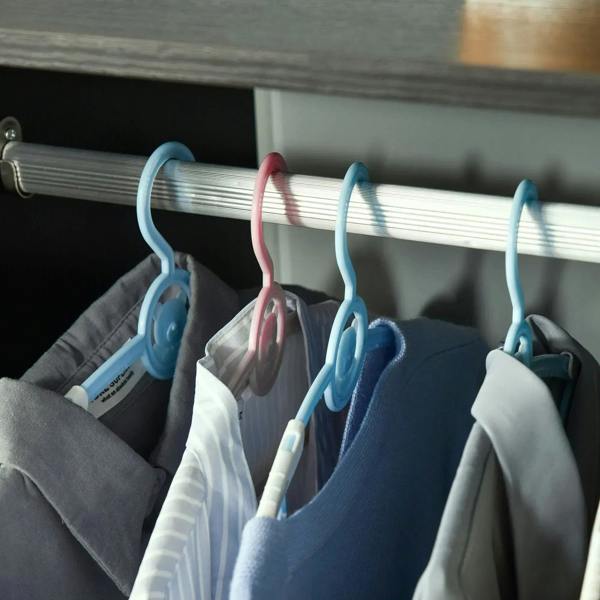 Hanging rail with assorted shirts and garments on blue hangers