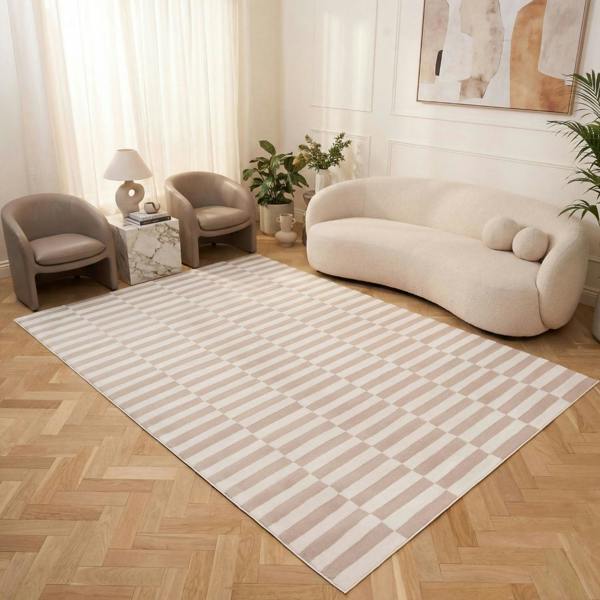 Living room with a striped rug, beige sofa, and decorative items.
