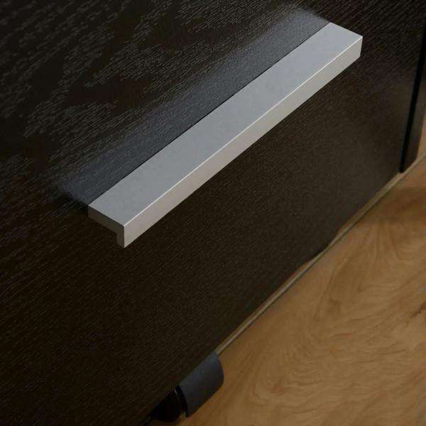 Black filing cabinet drawer front with metal handle and caster wheel