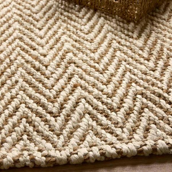 Close-up of a textured beige and brown rug with a herringbone pattern.