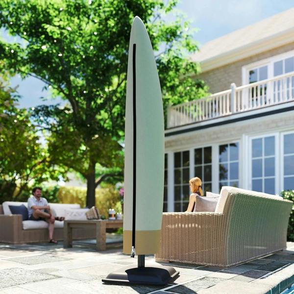 Beige cantilever umbrella cover over umbrella, black base stand visible on patio
