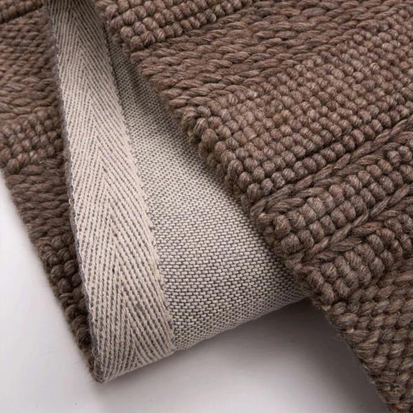 Close-up of brown textured fabric on a white background