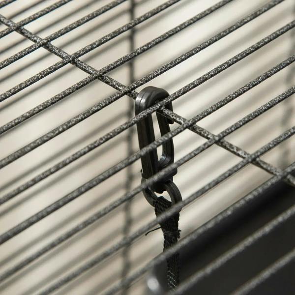 Close-up of black latch on silver wire small animal cage door