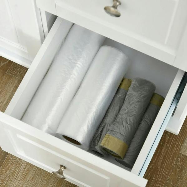 White pull-out drawer in a kitchen island cart with space for folded linens