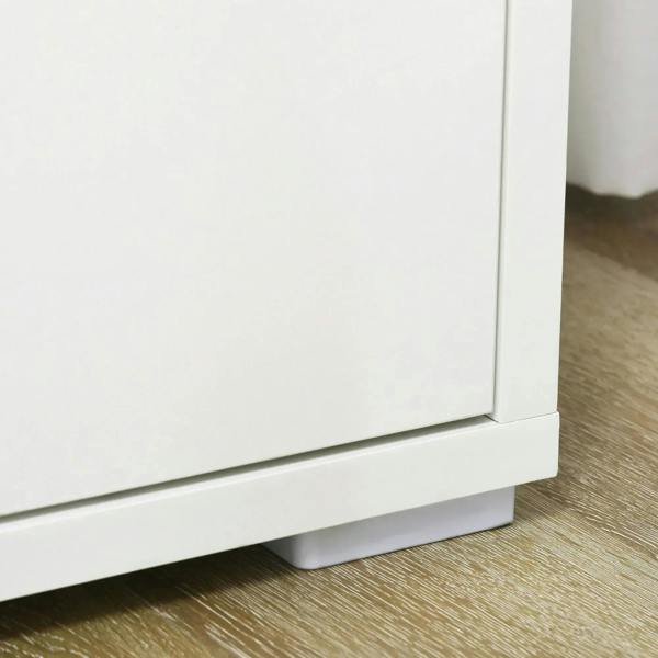 Bottom corner of white double-door storage cabinet with raised base