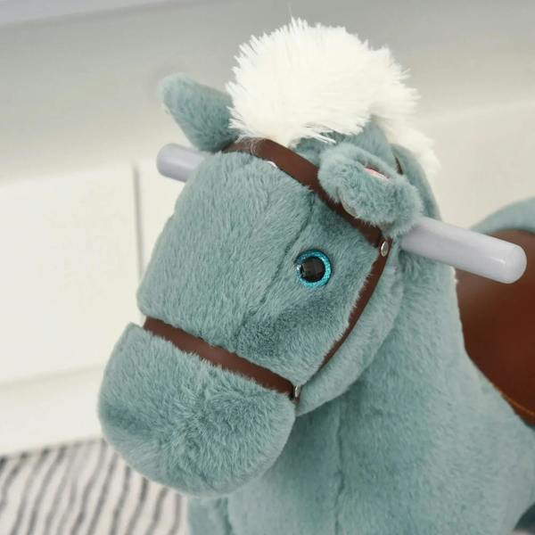 Blue plush rocking horse close-up with blue eye and brown bridle