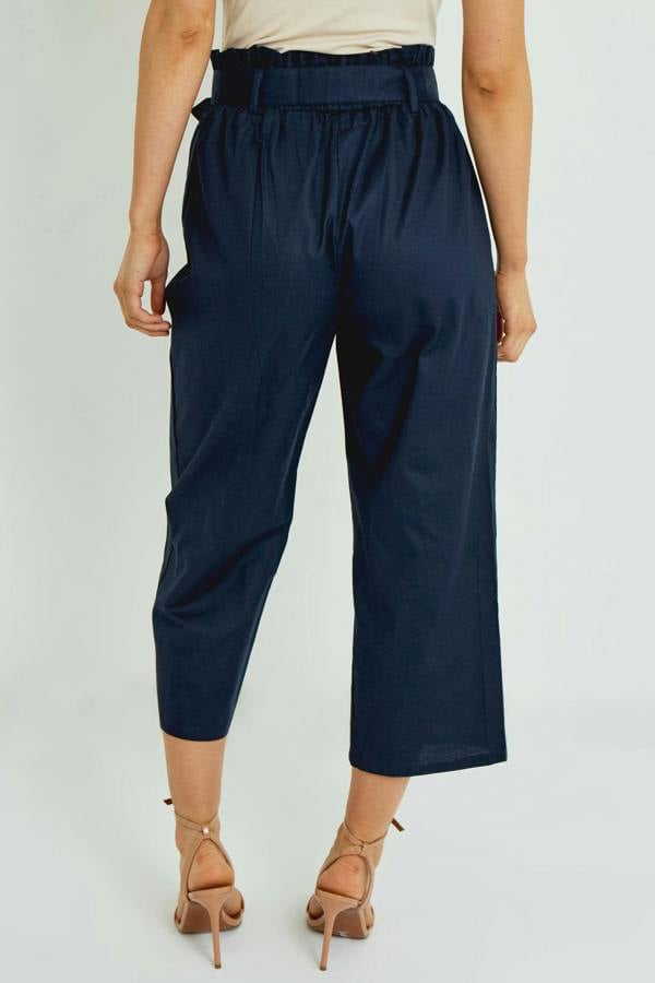 Person wearing navy blue pants on a white background