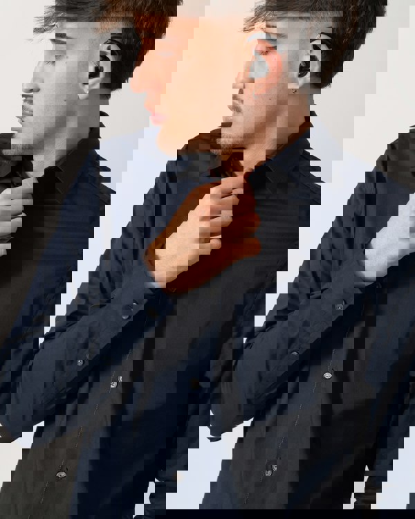 Close up shot of a Model wearing a Ted Baker Baxters Mens Long Sleeve Slim Stretch Shirt in Navy