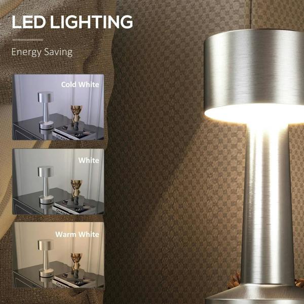 Silver cordless table lamp with warm lit glow from cylindrical shade