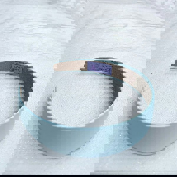 Light blue hairband, smooth satin finish, soft pastel shade, padded structure, minimalist design, elegant everyday accessory
