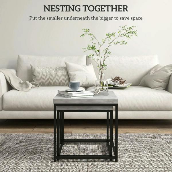 Grey square nesting coffee table with black frame, styled beside a sofa