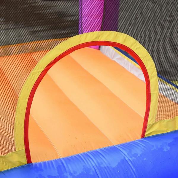 Close-up of orange inflatable slide entrance with mesh side wall and yellow safety trim