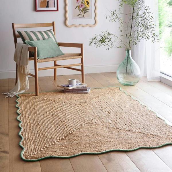 Woven rug on a wooden floor with a chair and decorative elements.