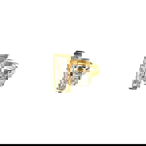 Gold ring with rectangular and round gemstones on a white background