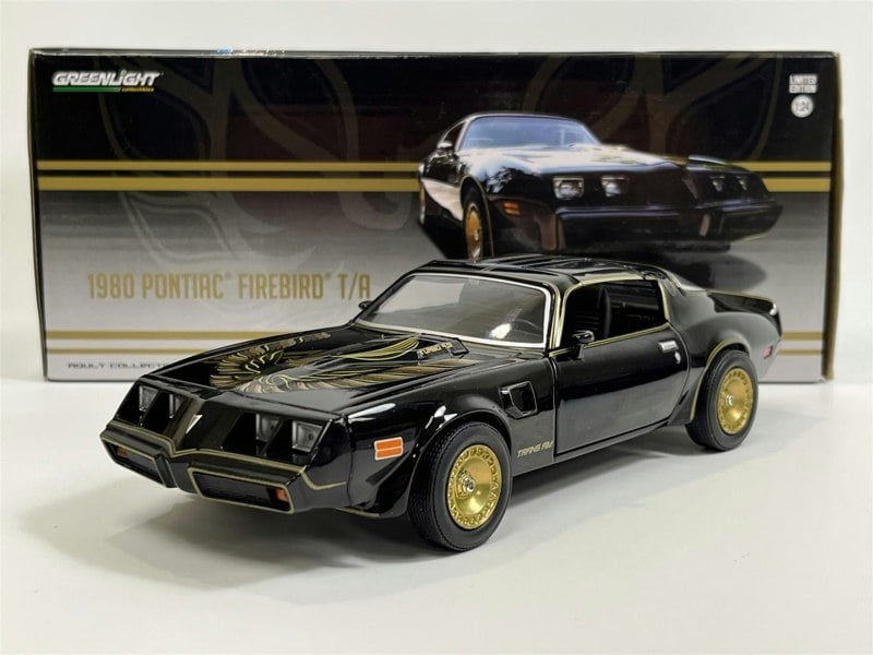a black toy car in a box