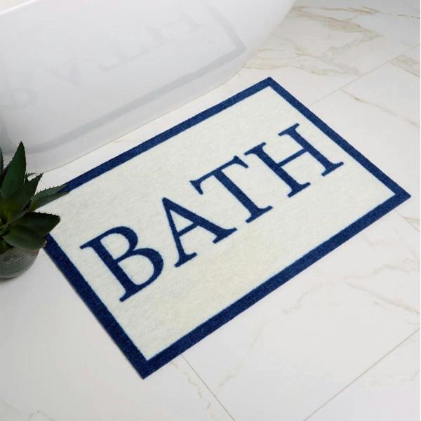Bath mat with 'BATH' text on a bathroom floor