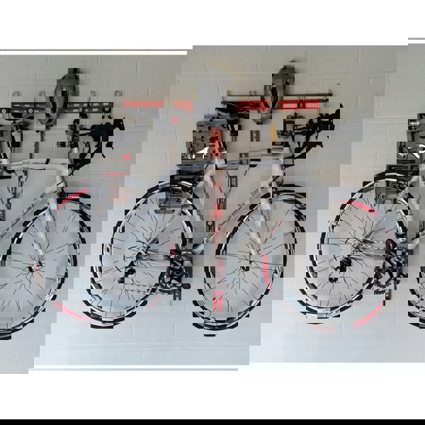 Horizontal bike rack, wall mounted bike storage with a road bike, helmet and tools