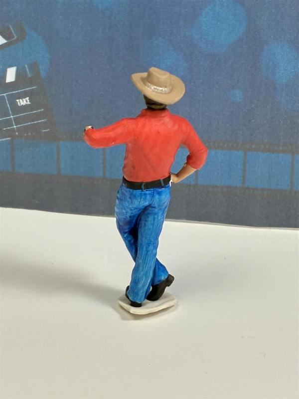 a toy figure of a man wearing a hat