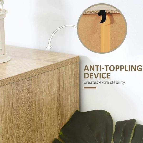 Natural wood dresser corner with anti-toppling strap and black metal base detail.