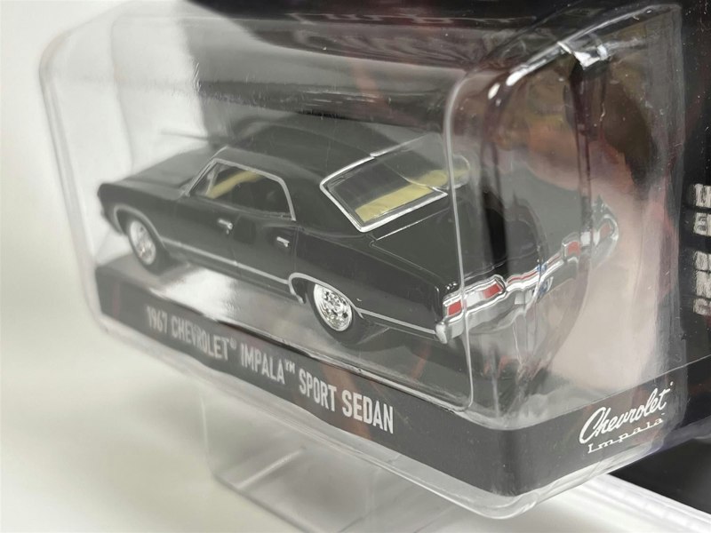 a black toy car in a plastic case