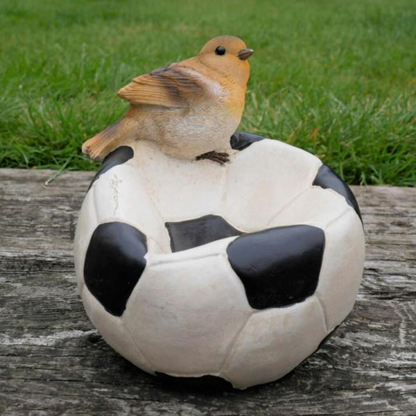 Robin sitting on a ball bird feeder
