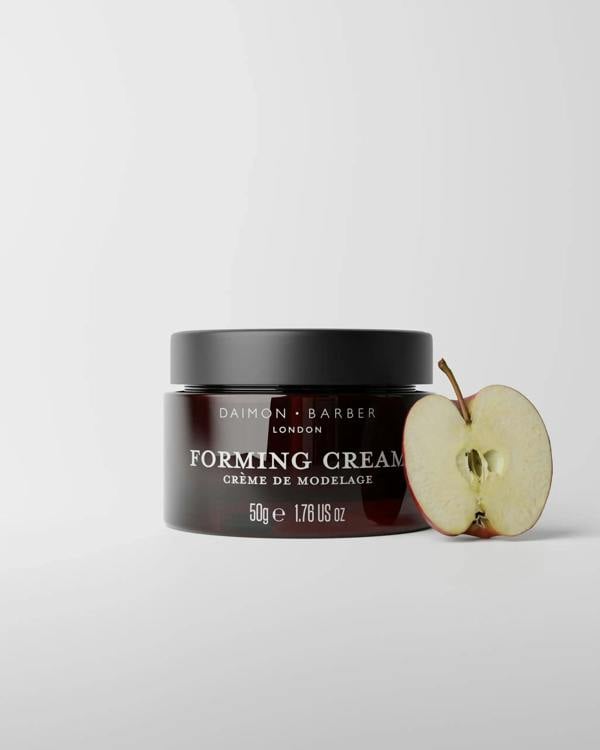 Jar of 50g Forming Cream with apple on grey background.