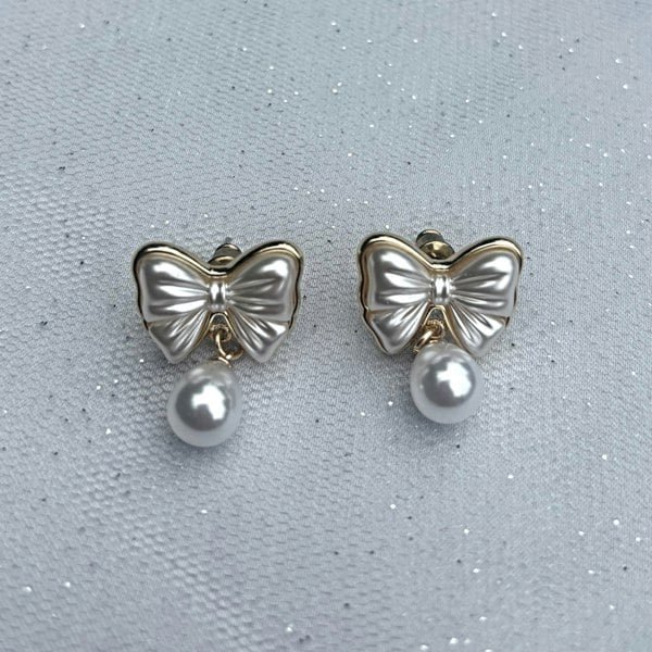 Pearl Drop Bow Earrings, Front View, Gold Bow Earrings With Pearl Drop, Elegant Clip On Earrings, Feminine Vintage Inspired Jewellery, Classic Gold And Pearl Statement Earrings
