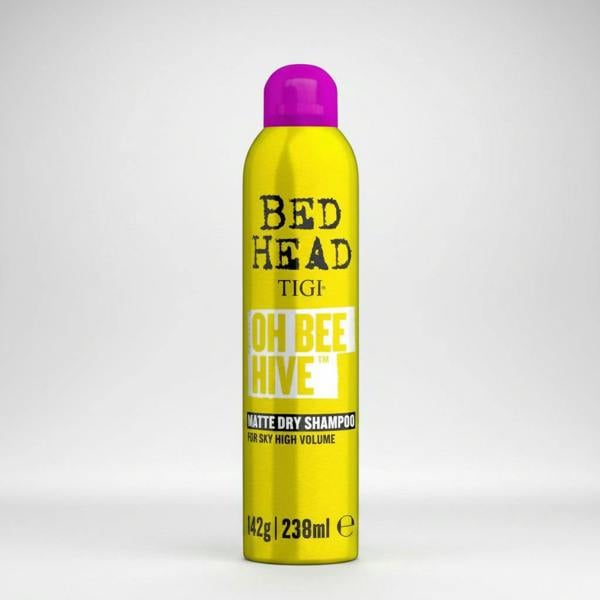 Yellow bottle of TIGI Bed Head Oh Bee Hive dry shampoo on a white background