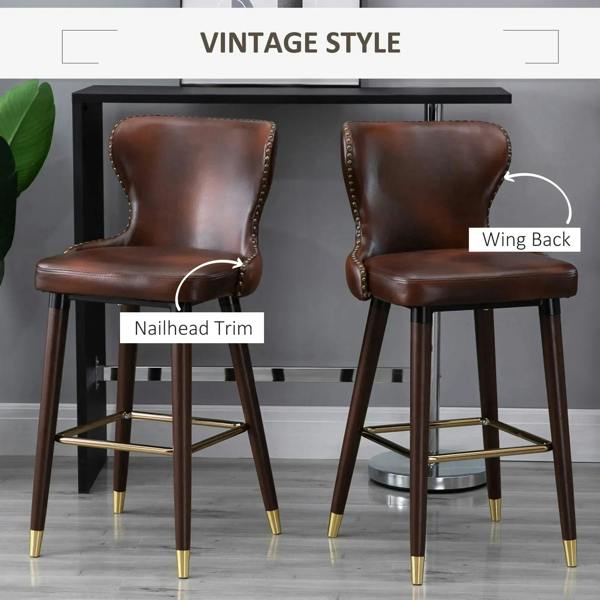 Brown PU leather bar stool with wing back, nailhead trim, and footrest on wood legs