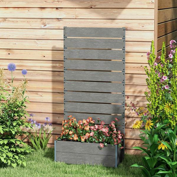 Dark grey garden planter box with back trellis and flower arrangement in outdoor yard