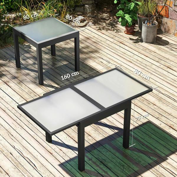 Extendable outdoor table with black aluminum frame and clear tempered glass top, expanded