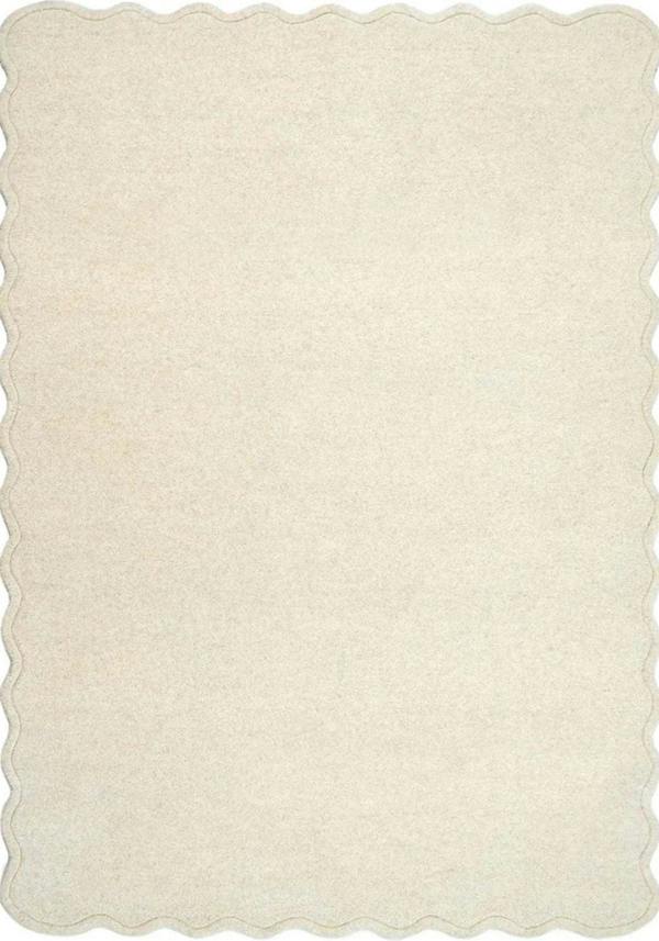 Beige rug with scalloped edge on a white background