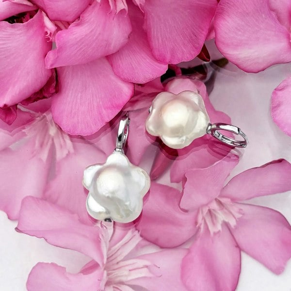 Flower shaped pearls suspended from sterling silver hoops by LENAE London.