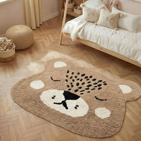 Children's room with a bear-shaped rug on a wooden floor.