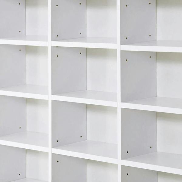 Close-up of white compartment shelves with square cubbies and fixed panel supports