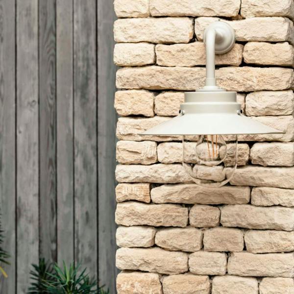HMS Belfast inspired deck light in a gloss Clay finish, mounted on a light stone wall with a grey wood-cladding backdrop.