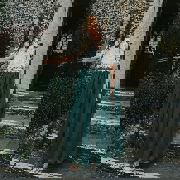 bridesmaid wearing hunter green skirt and lace top