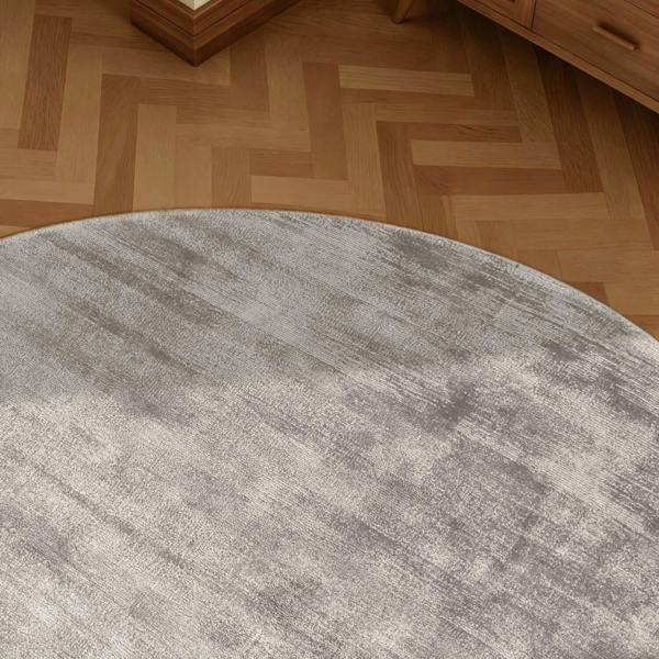 Round gray rug on a wooden floor