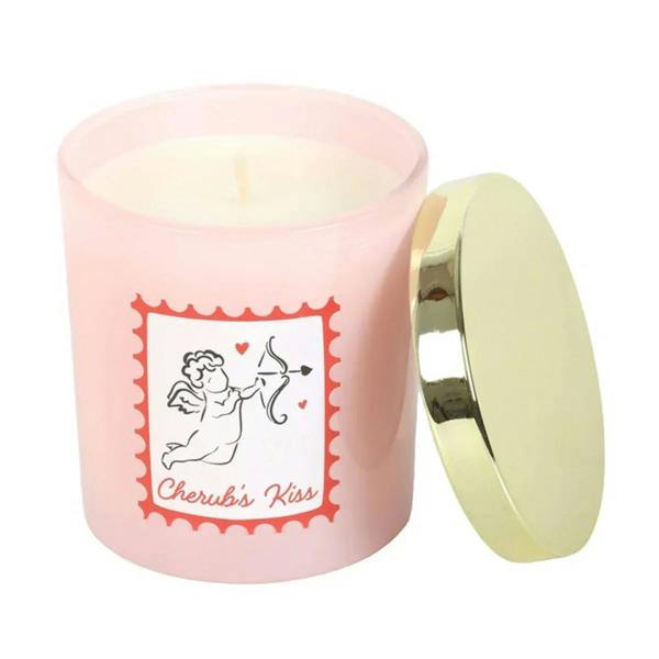 Pink scented candle jar with gold lid and cherub label, lid open
