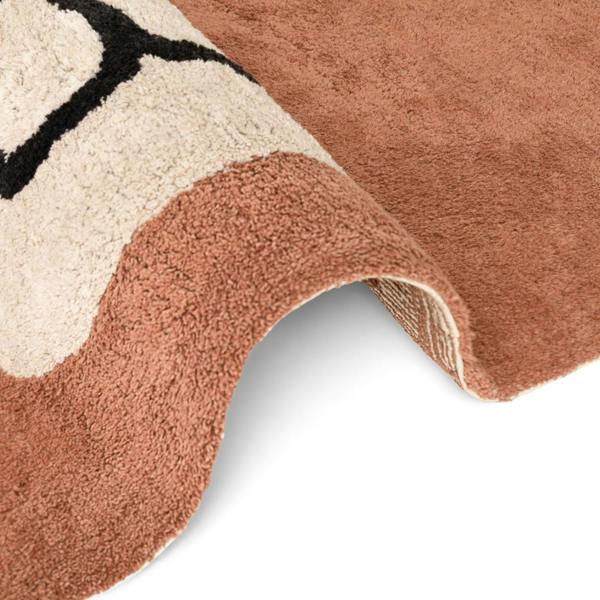 Close-up of a textured rug with geometric pattern on a white background